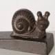 Cale-porte oiseau ou escargot en fonte